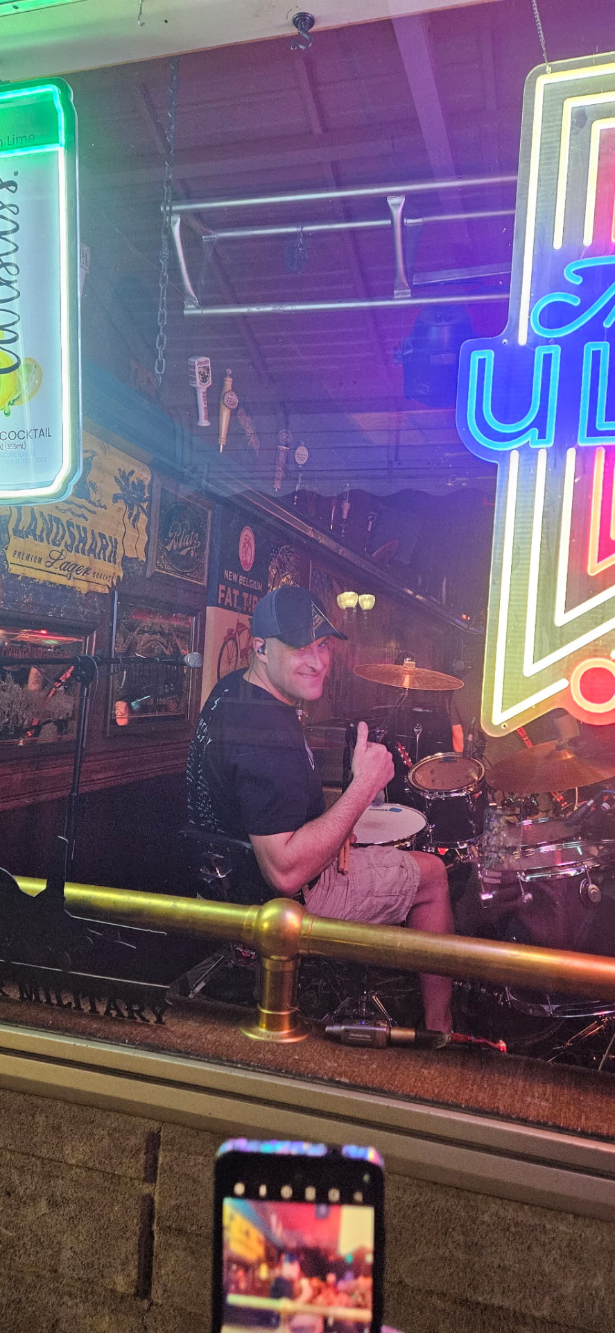 Drummer giving a thumbs up behind the kit at the bar