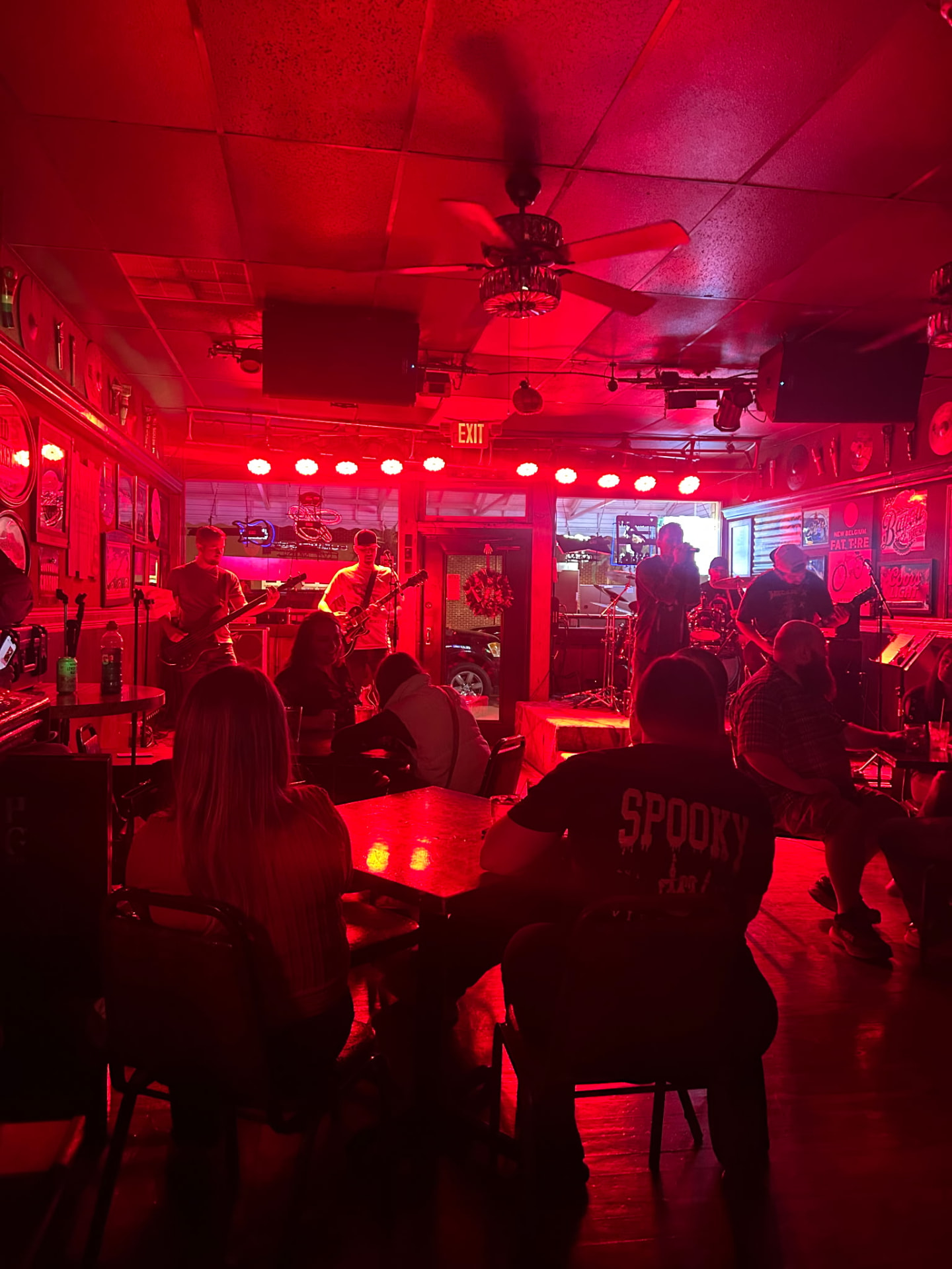 Crowd watching the band in a bar washed in red light